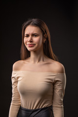 Fototapeta premium Closeup photo portrait of unsatisfied tired crying woman on black background