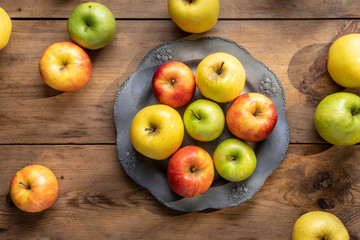 Group of fresh apples on wooden table from above