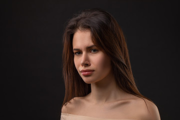 Closeup photo portrait of unsatisfied tired crying woman on black background