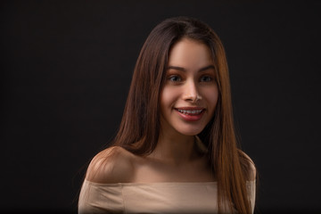 Sarcasm emotion Brunette girl portrait against black background