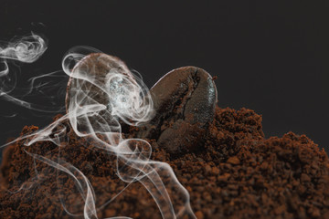 Coffee beans roasted dark and mashed on a  with a dark background