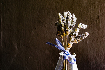 dried lavender tied with a purple bow on a gray rustic background