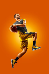 Plakat bright professional basketball player on an orange background