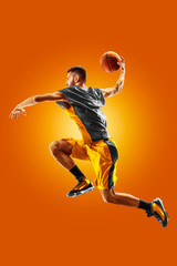 Fototapeta na wymiar bright professional basketball player on an orange background