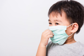 Closeup Asian face, Little children boy sick he using medicine healthcare mask