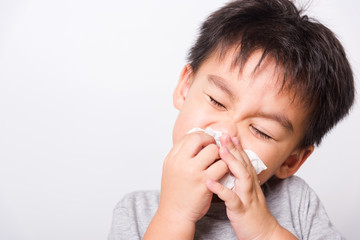 Fototapeta na wymiar Closeup Asian face, Little children boy cleaning nose with tissue