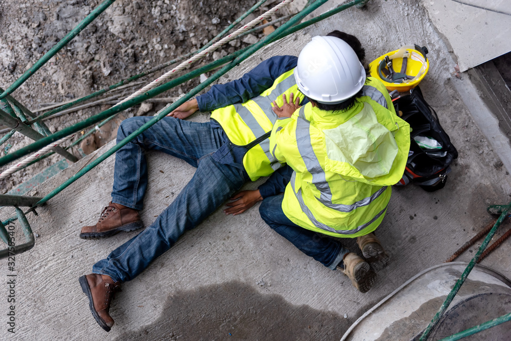 Wall mural first aid support accident at work of construction worker at site. builder accident falls scaffoldin