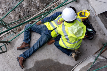 First aid support accident at work of construction worker at site. Builder accident falls...