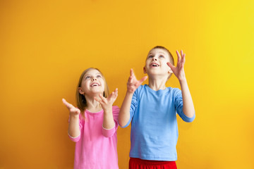 cute kids on an orange background that then catch falling from above