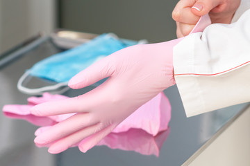 Close up putting on latex gloves.