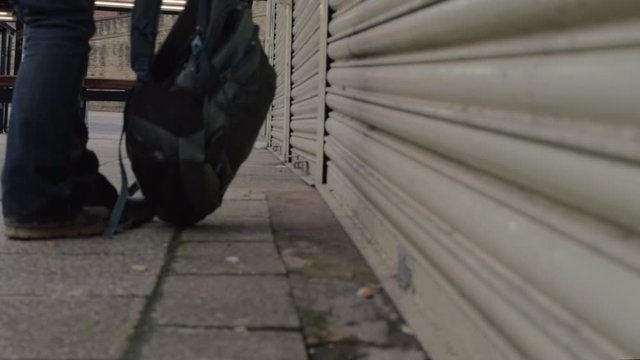 Person leaves rucksack in empty market stalls and walks away
