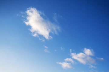 Naklejka na ściany i meble Small clouds in the blue sky, copy space for text, background