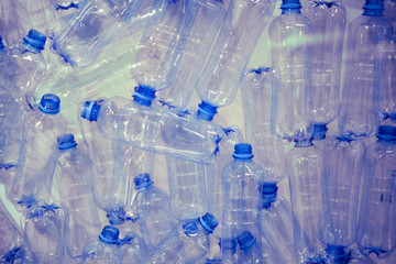 Empty plastic bottles with blue lids, close-up