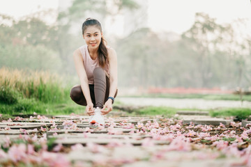 Younger beautiful wrinkle Asian run To exercise In the park City center sunlight good weather Stretch relax On vacation In the morning bright Health care