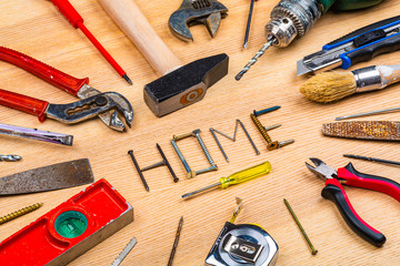 Assortiment d'outils de bricolage autour du mot Home avec arrière-plan en bois