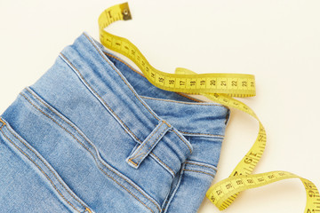 A ruler and red apple for measuring waistline on jeans