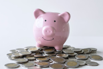 Images of stacking coins pile and pink smiling piggy bank to growing and savings with money box, Saving money for future plan and retirement fund concept