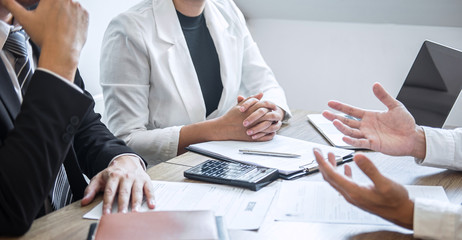 Employer or recruiter holding reading a resume with talking during about his profile of candidate, employer in suit is conducting a job interview, manager resource employment and recruitment concept