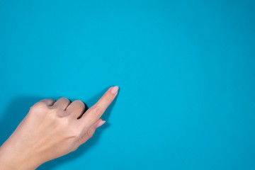 Closeup top view photography of one female manicured finger with forefinger showing at something...