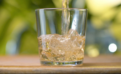 Glass of apple juice pouring