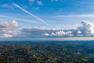 The panoramic view of Côte d'Azur under the cloudy sky and the Meditarrenean sea coastline in the horizon