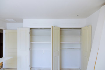 Interior of white shelf or clothing with many empty shelves with installation.