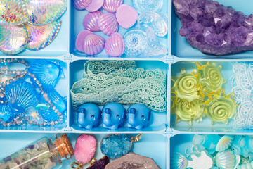Toy figures of shells, elephants, fish, crystals, lace and other cute treasures in a box, all sorts of things for developing our imagination games and creativity