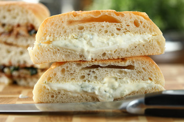 Tasty sandwich with melted cheese on a wooden board closeup background. Healthy food concept