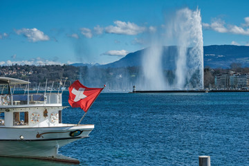 panoramic view of the lake, the water jet and an old steamboat in Geneva, Switzerland - obrazy, fototapety, plakaty