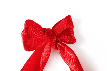 Close-up red silk ribbon small bow isolated on white background