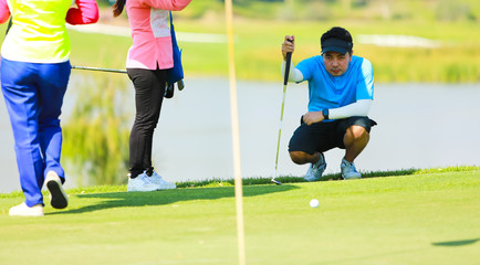 Obraz premium Professinal golf player on golf course. Pro golfer taking a shot