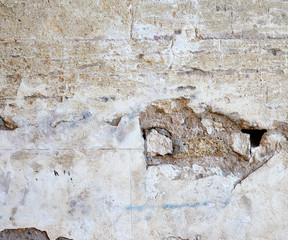 wall of yellow rectangular stones with cement