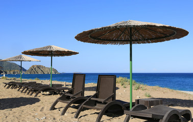  straw beach umbrellas on seashore