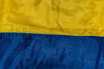 A close-up shot of the Ukrainian yellow and dark blue national flag