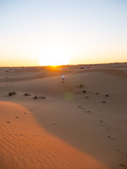 Person on sand dunes in dubai UAE summer