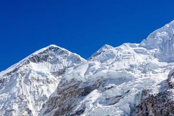 Fototapeta na wymiar White snowy mountans with blue sky on clear day. Everest base camp view. Himalayas. Nepal.