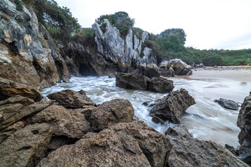 beautiful views of the smallest beach on planet earth, located in the north of spain, with rocks