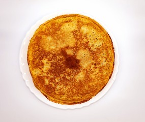 Top view of the holiday treat. There are pancakes in a white round plate