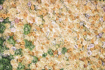 Fresh pale yellow flowers of roses, colorful natural handmade romantic wall background. Floral decor.