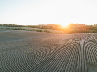 Aerial view. Rows of soil before planting. Plowed field prepared for planting crops in spring.