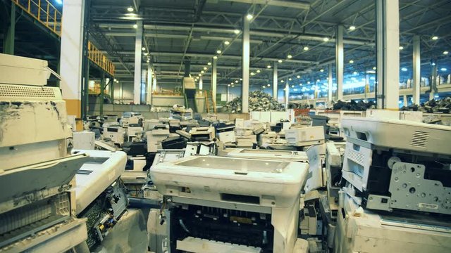 Discarded printers on a dump for recycling.