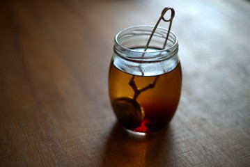 Tea in a glass jar on table