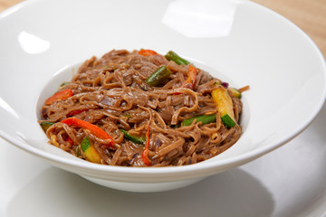 noodle with vegetables on the wooden background