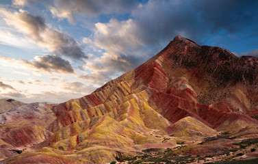 Rainbow mountains with blue sky in China at Zhangye Danxia geological park. Colorful rock formations with geological layers in the Gobi desert.
