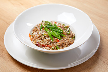 noodle with vegetables on the wooden background