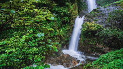 Travel the highest waterfall in Chiangmai Mae-pan waterfall rainy season forest at Doi intanon. background waterfall.