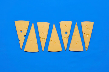 Hard Italian cheese a blue background. Top view