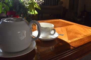 Blured focus of Pouring hot tea into a cup on wooden table background, Traditional english tea