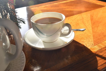 A cup of hot tea with milk on wooden table, Traditional english tea
