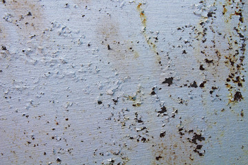 Old rusty metal sheet painted in silver color. Close-up. Background. Texture.